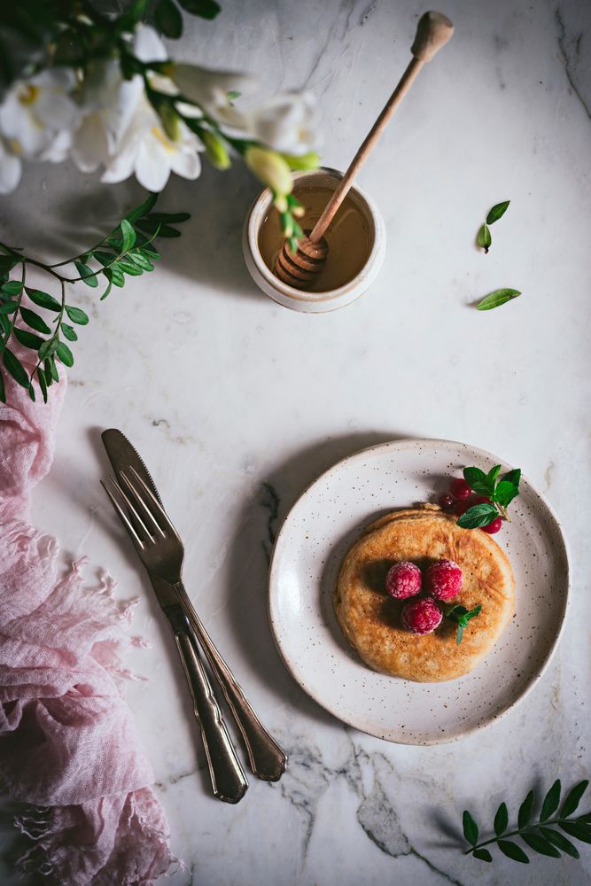 Pancake with fresh raspberry on plate