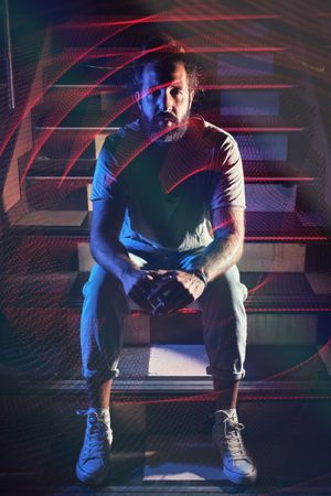 Man sitting on stairs in nightclub