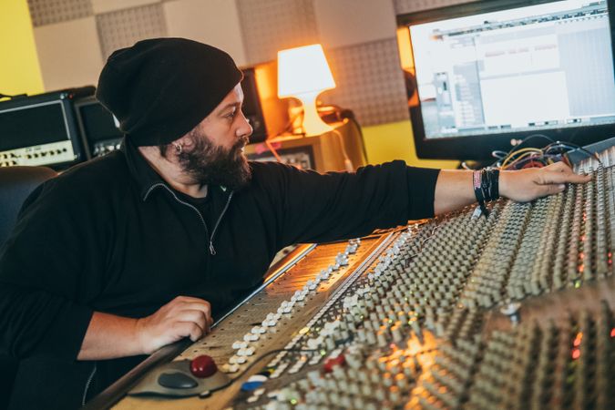 Man in a equalizer instrument in a studio