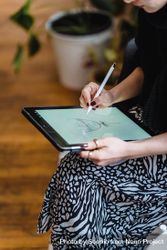 Cropped image of woman drawing on computer tablet 0gq674