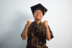Excited graduate in studio shoot