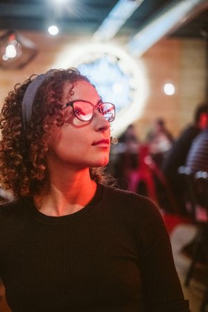 Dreamy woman in glasses looking away