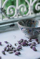 Dried flower buds and bowl near window