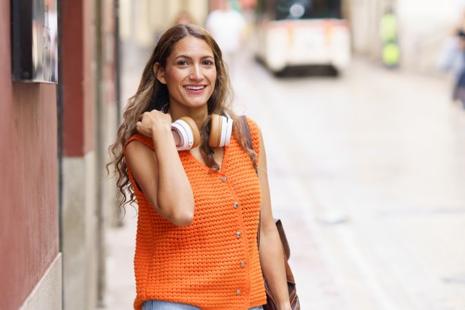 Latina woman smiling walking in the city