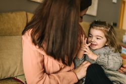 Woman hugging smiling daughter