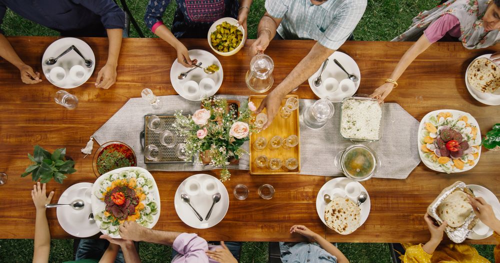 Big Indian Family Lunch Table: Top Down Elevated View at a Family and Friends Celebrating Outside at Home.