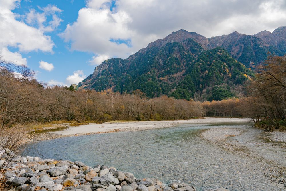 landscape view of japan alps mountain with natural forest, blue river on autumn season at kamikochi Nagano.