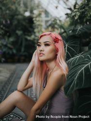 Woman with pink hair sitting among trees 5z6dP5