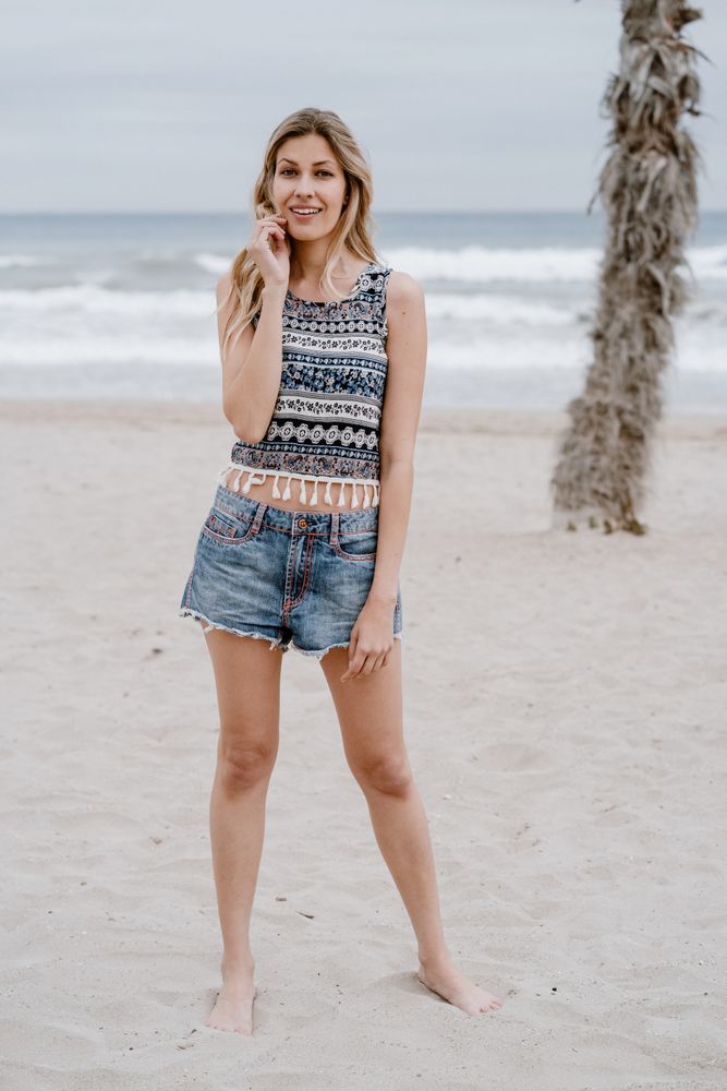 Happy female laughing on sandy beach