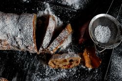 Pieces of Stollen near sieve and autumn leaves