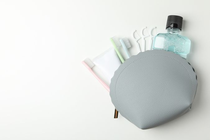 Bag with tools for dental care on light background