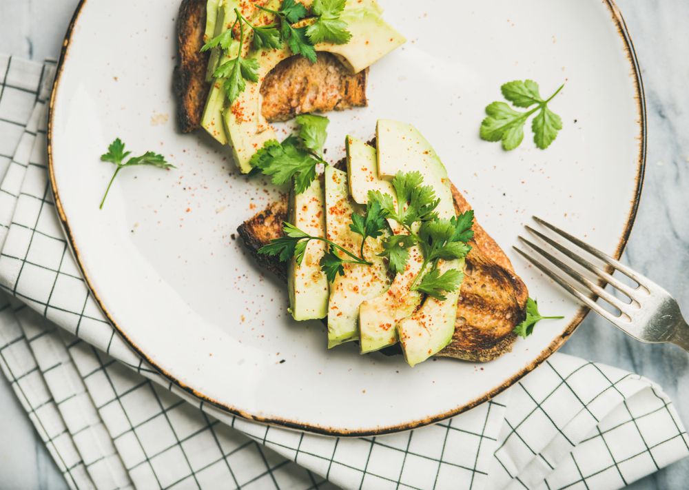 Homemade avocado toast with herb garnish