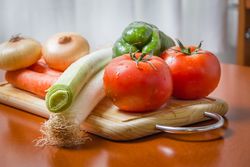 Fresh vegetables on cutting board in the kitchen