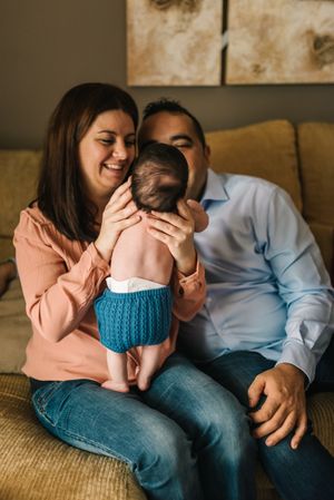 Happy family sitting on couch together