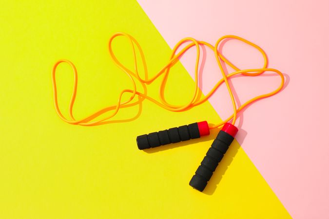 Jump rope on two tone background, space for text