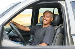 Smiling woman driving car