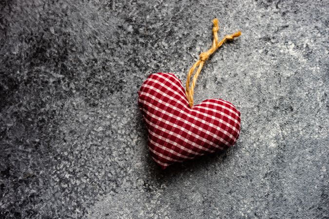 Valentine's day concept with red checkered heart decoration on grey counter