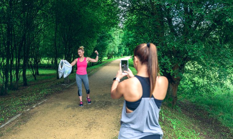 Woman taking picture of a friend after plogging