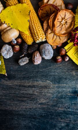 Top view of wooden table with seasonal nuts, berries, vegetable and fruits for fall