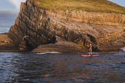 Woman on paddleboard floating in sea