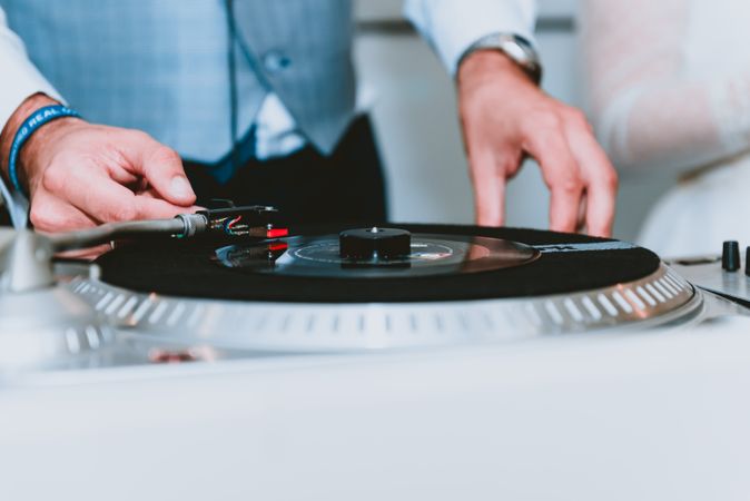 Crop man clicking plays records