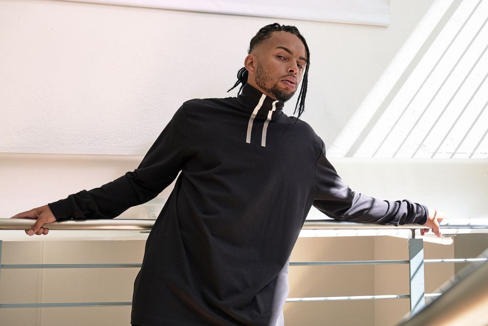 Trendy Black male standing indoors