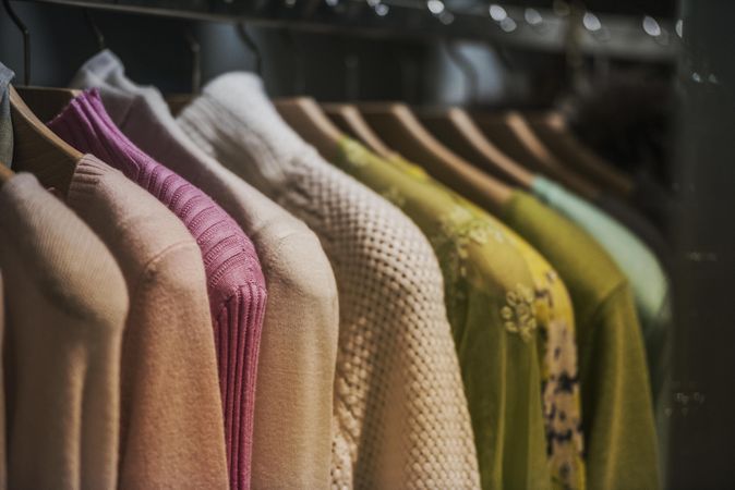 Clothes rack of sweaters in close-up in fashion store