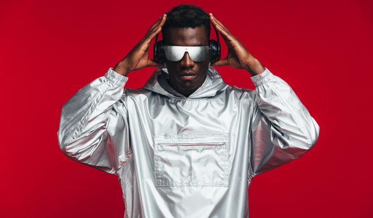Man dressed like a robot on red background