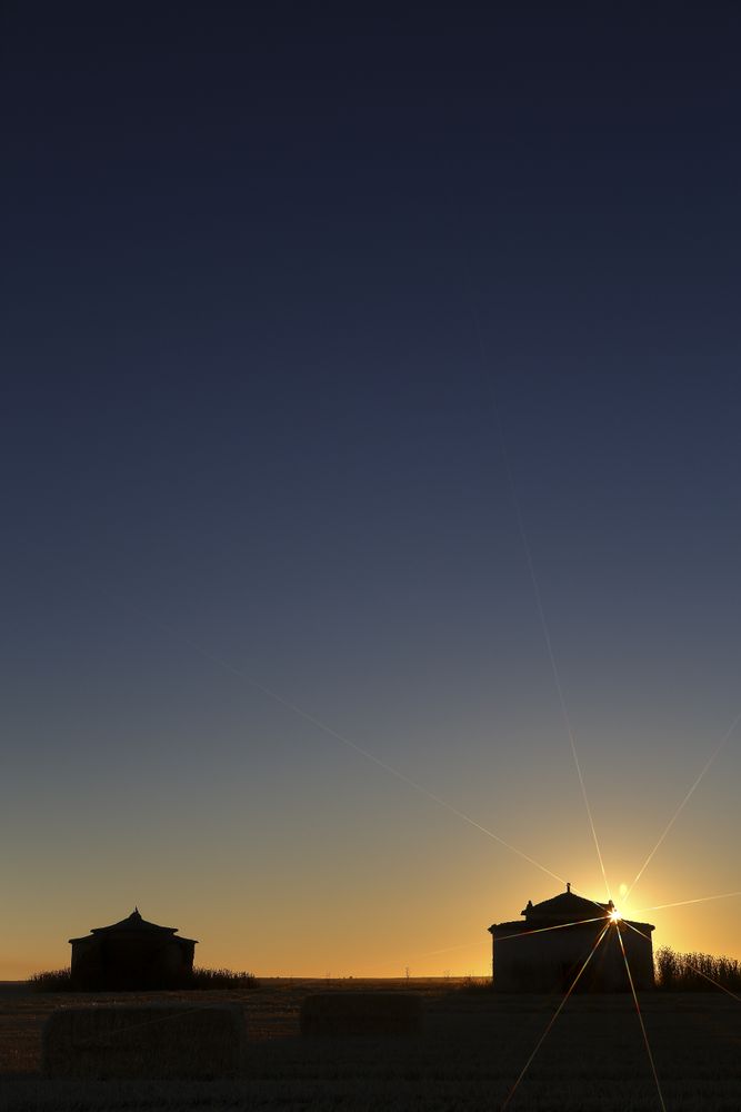 Aged house in rural countryside under starry sky