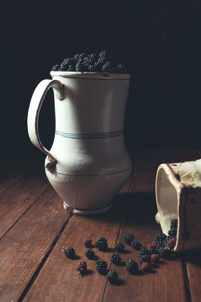decanter full of blackberries on table