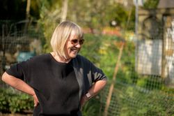 Woman with hands on hips in garden