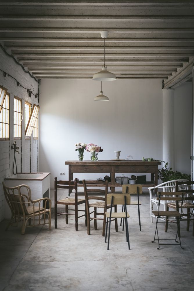 Empty room with flowers on table and chairs