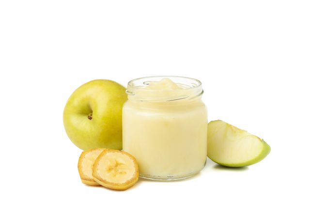 Glass jar with healthy baby food isolated on plain background