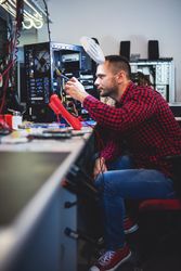 Man repairing PC at workplace