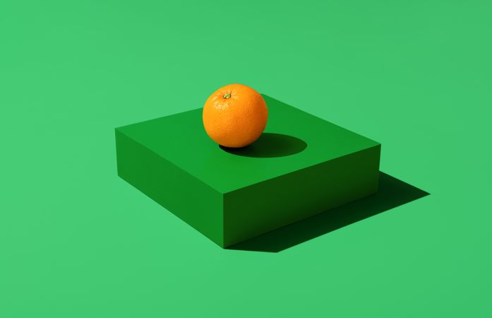Single orange isolated on green background