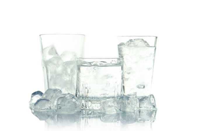 Three glasses full of water and surrounded by ice