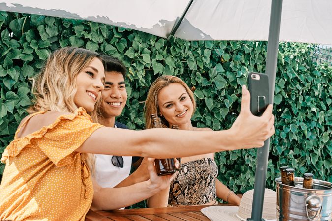 a group of young people making a selfie with last generation mobile phone
