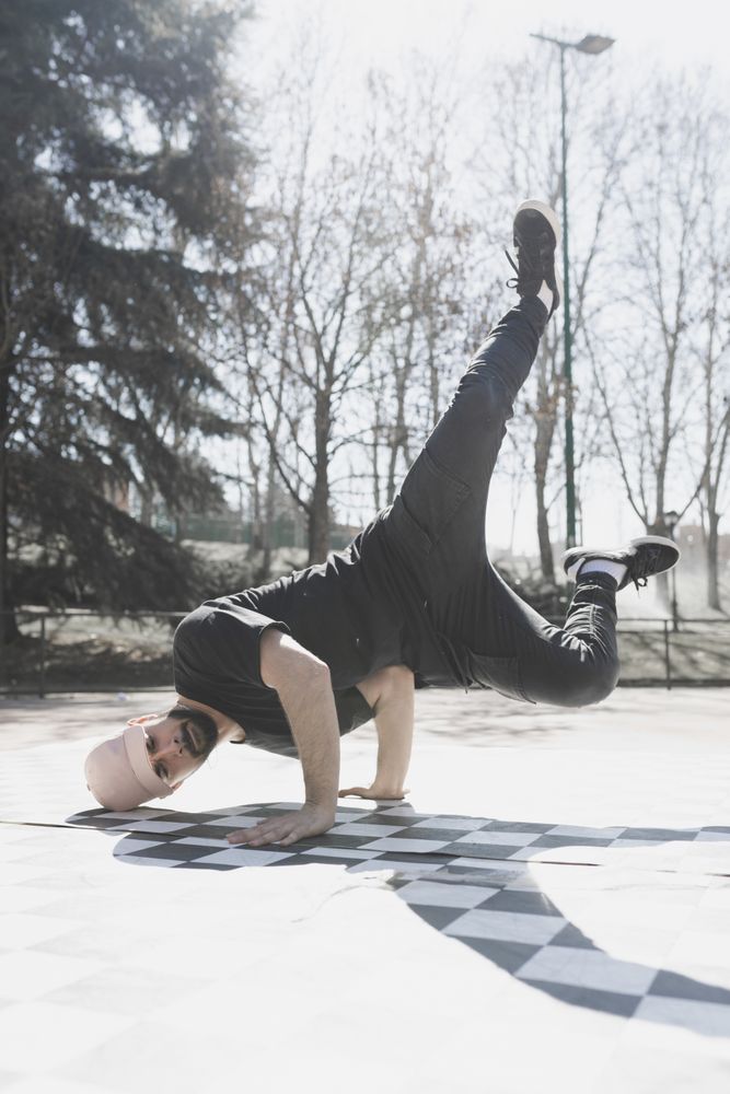 Man dancing break dance in park