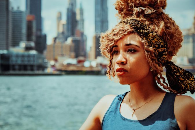 Close up portrait of serious young Black woman with Hudson River in the background