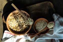 Top view of bowls of dry oats on kitchen counter