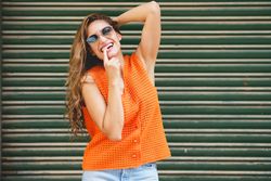 Cute woman with sunglasses flirting with the camera