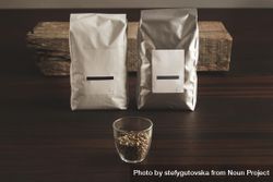 Bags of coffee beans and glass of beans 5aWzAb