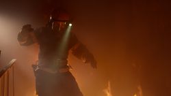 Firefighter runs down burning stairs