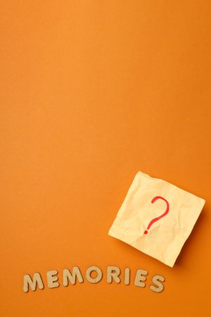 Post it not with question mark on dusty orange background, vertical