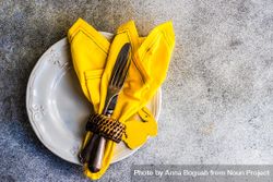 Easter table setting on concrete background with yellow napkin bYqGpj