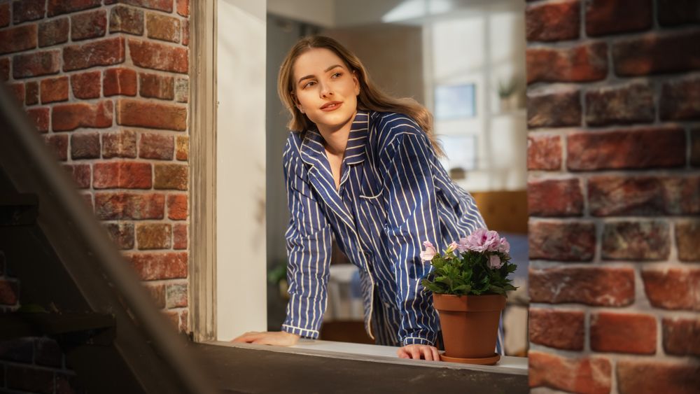 Young Female in Pyjamas Relaxing and Starting her Day with Wellbeing and Positivity