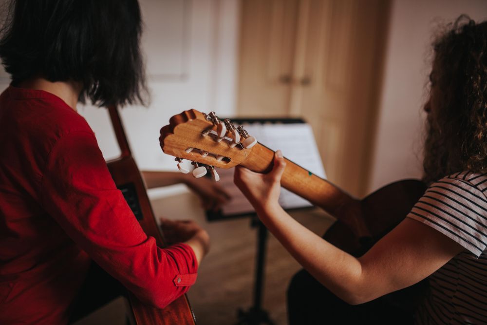 Two classmates studying duet song for band performance