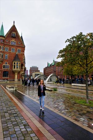 Blonde woman standing near brown building in Hamburg, Germany