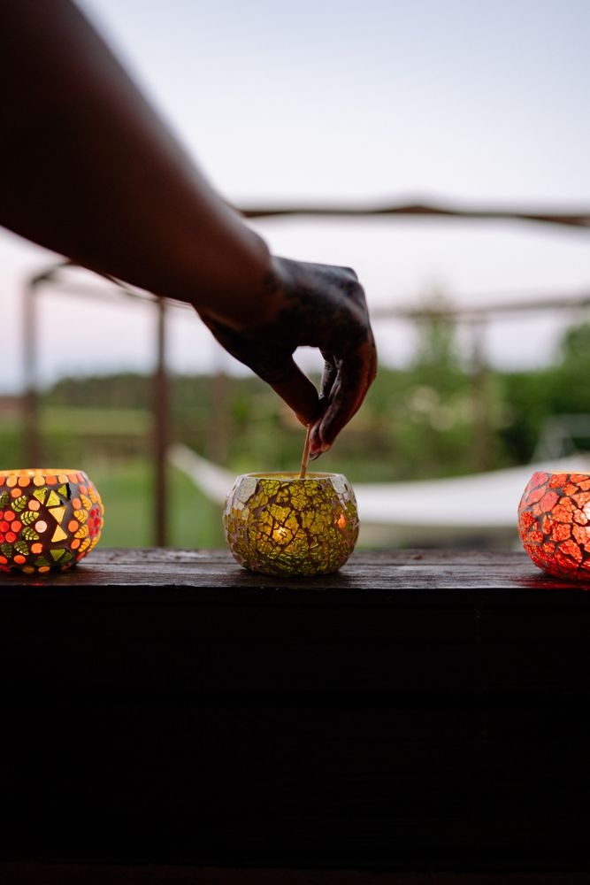 Person light up a candle in floral ornament