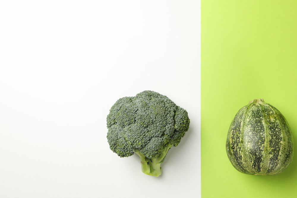 Zucchini and broccoli on two tone background
